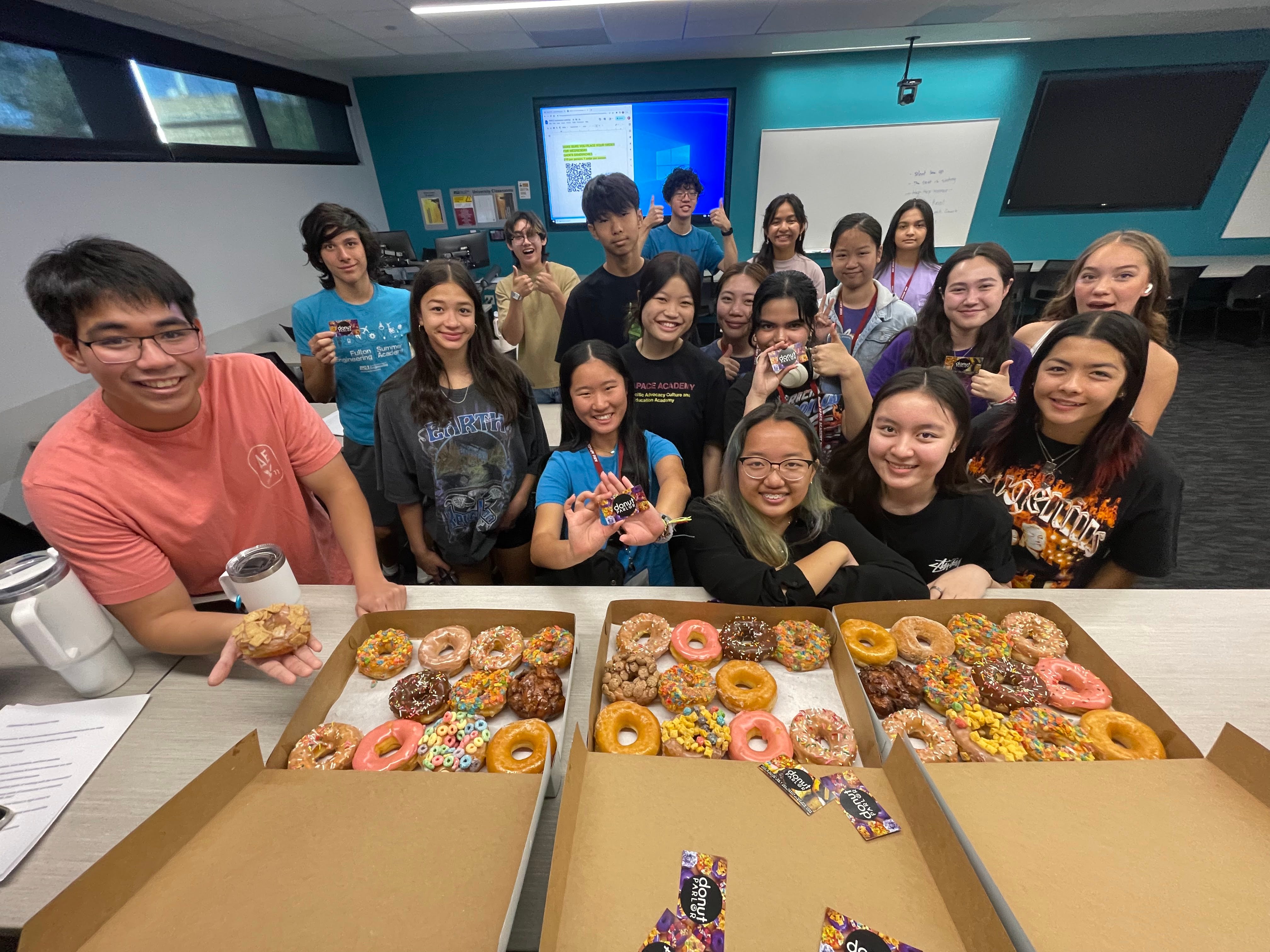 Group photo of 2023 APACE Academy students with donuts
