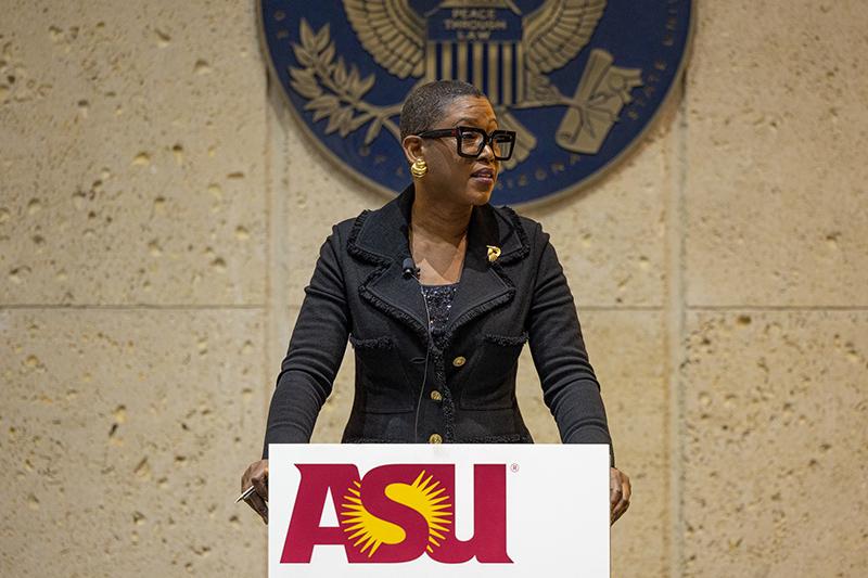 Michele Goodwin speaks at a podium at Arizona State University.